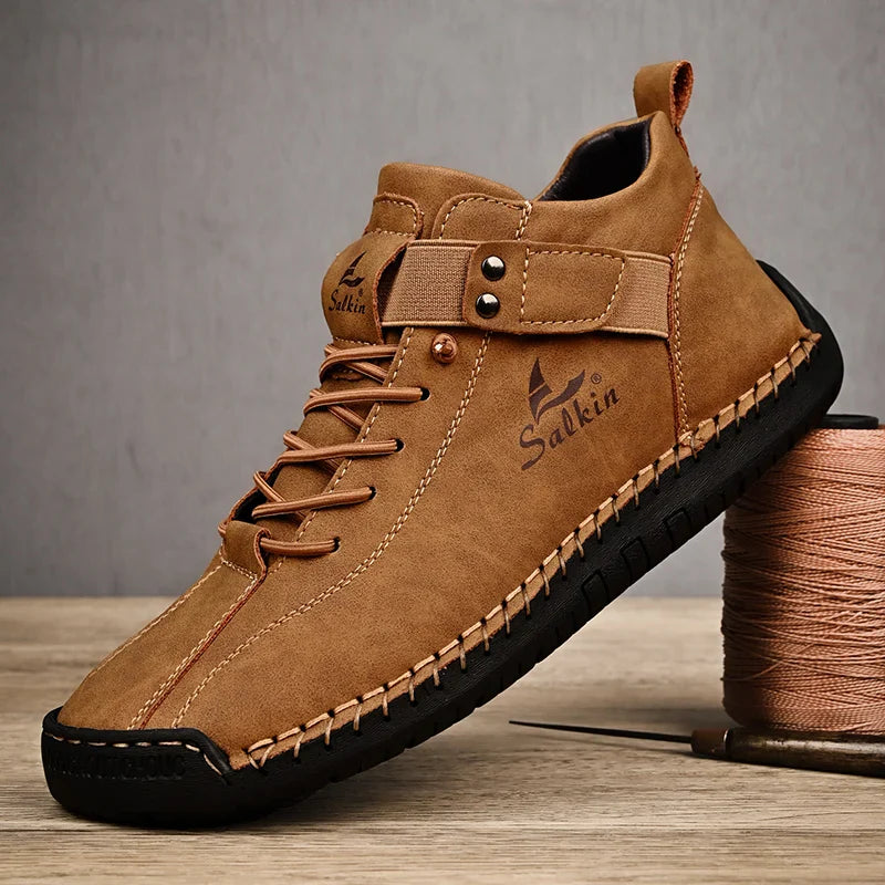 Brown leather shoe with black sole on a wooden surface, featuring the brand 'Salkin'.