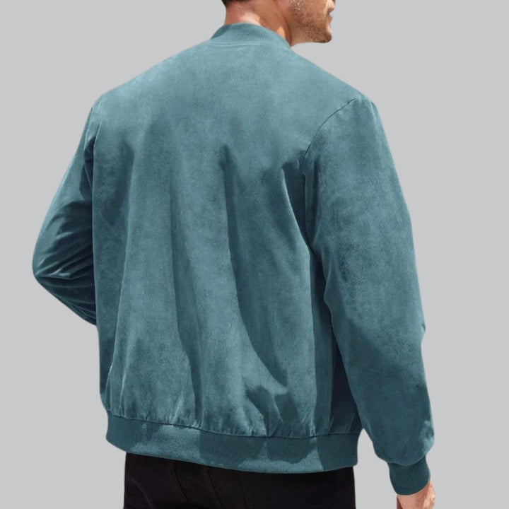 Teal jacket worn by a person on a gray background