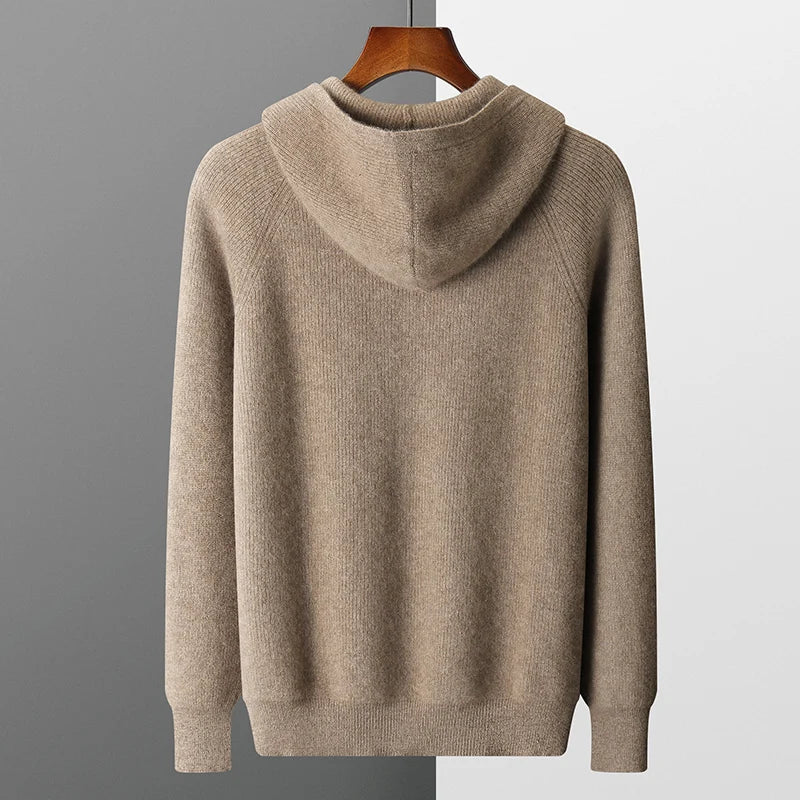 Beige hoodie on a hanger against a gray background
