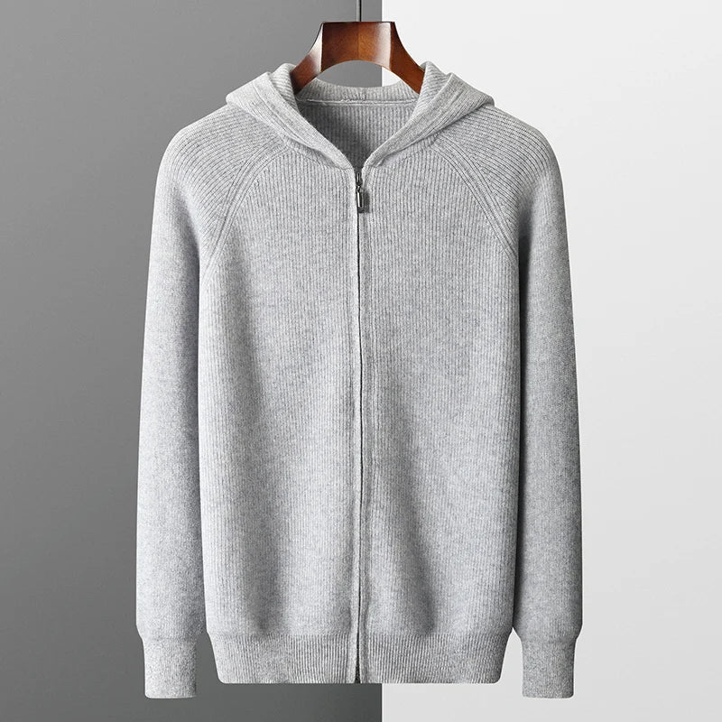 Gray zip-up hoodie on a hanger against a gray background