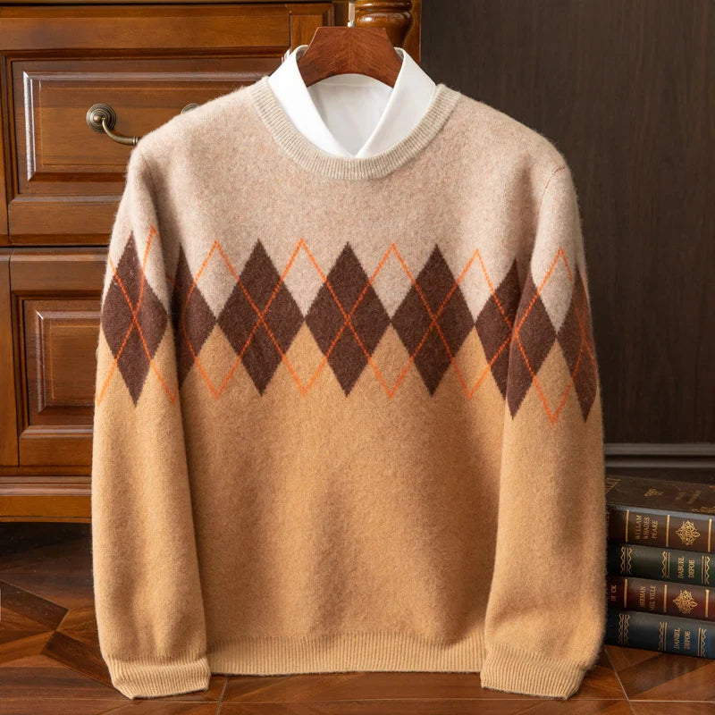 Beige sweater with diamond pattern on a hanger against a wooden cabinet background