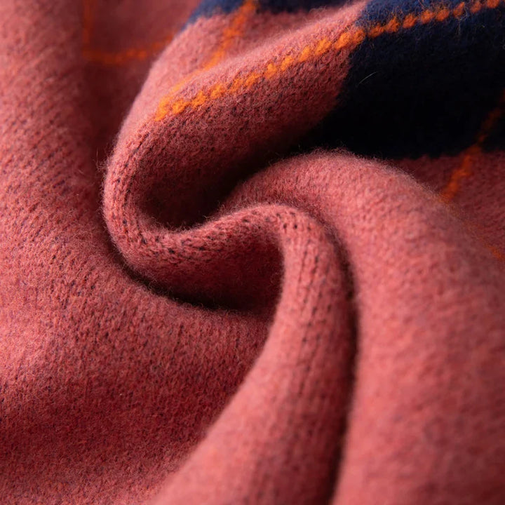 Close-up of a textured fabric with a plaid pattern in red, orange, and blue.