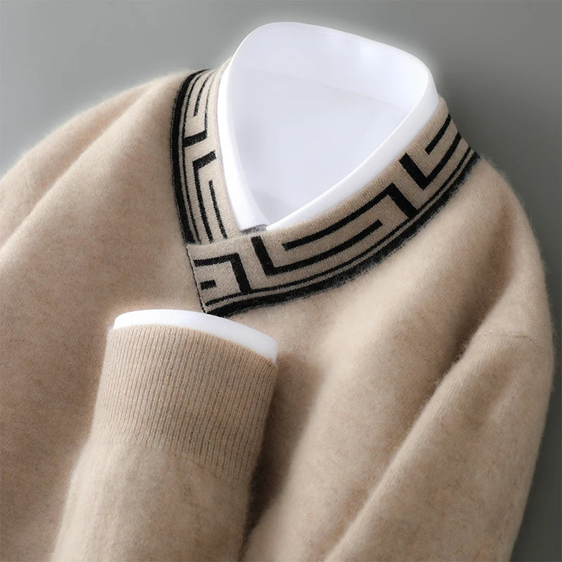 Beige sweater with a black and white patterned collar on a gray background