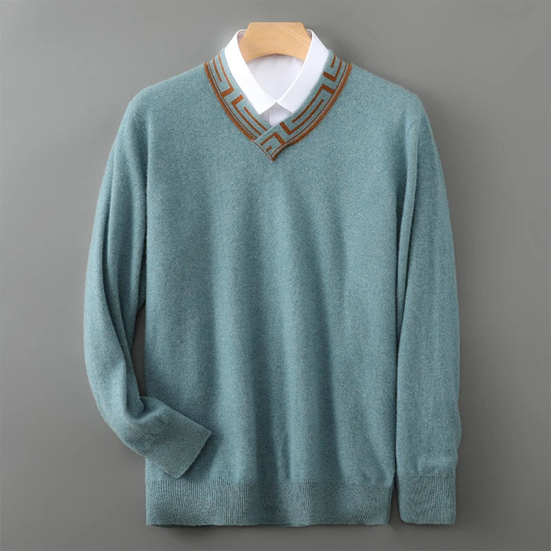 Teal sweater with brown trim on a wooden hanger against a gray background
