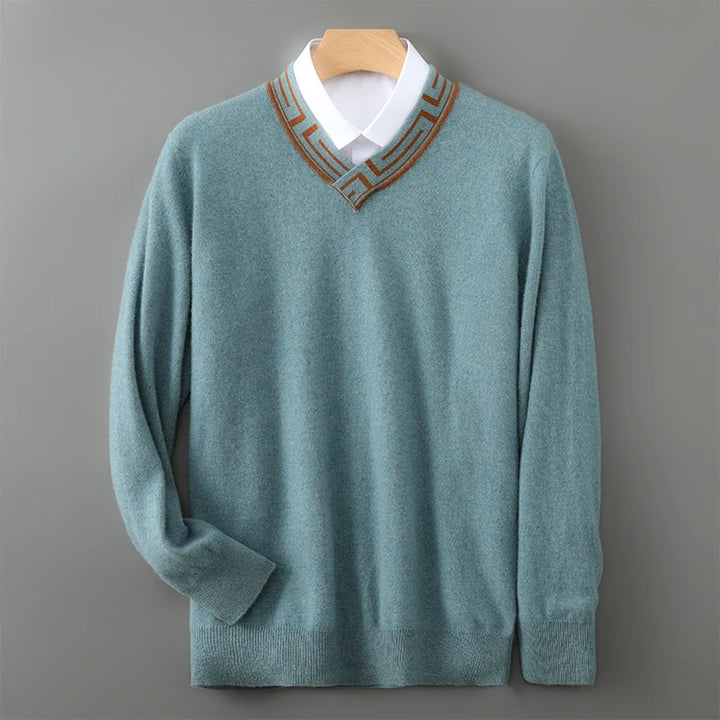 Teal sweater with brown trim on a wooden hanger against a gray background