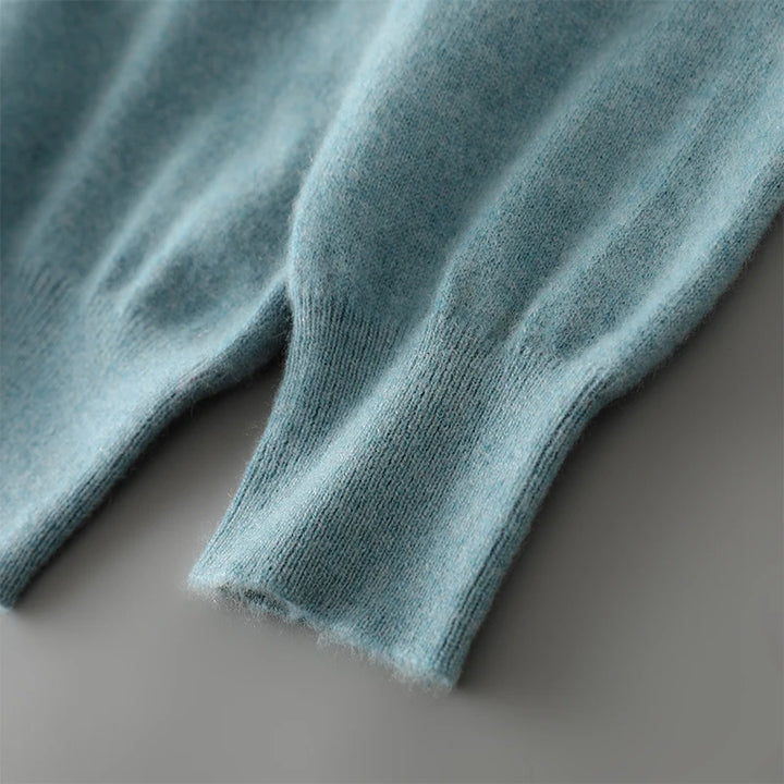 Close-up of teal knit fabric on a neutral background