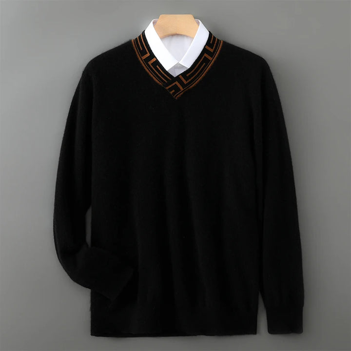 Black sweater with a white shirt and brown collar on a gray background