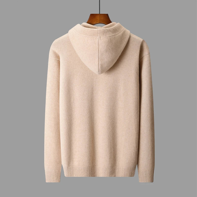 Beige hoodie on a hanger against a gray background