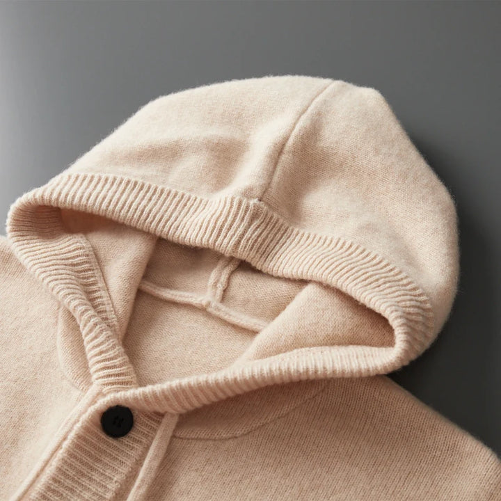 Close-up of a beige hooded garment with a dark background
