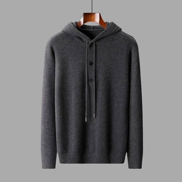 Gray hoodie on a hanger against a gray background