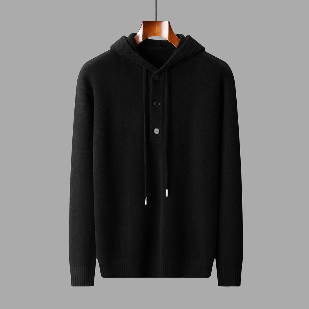 Black hoodie on a wooden hanger against a gray background
