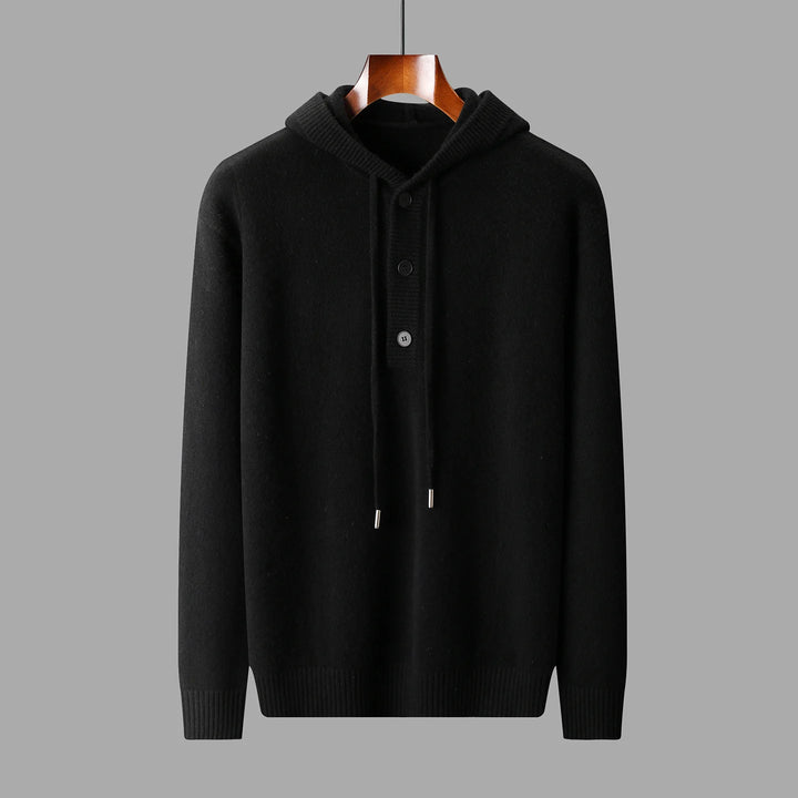 Black hoodie on a wooden hanger against a gray background