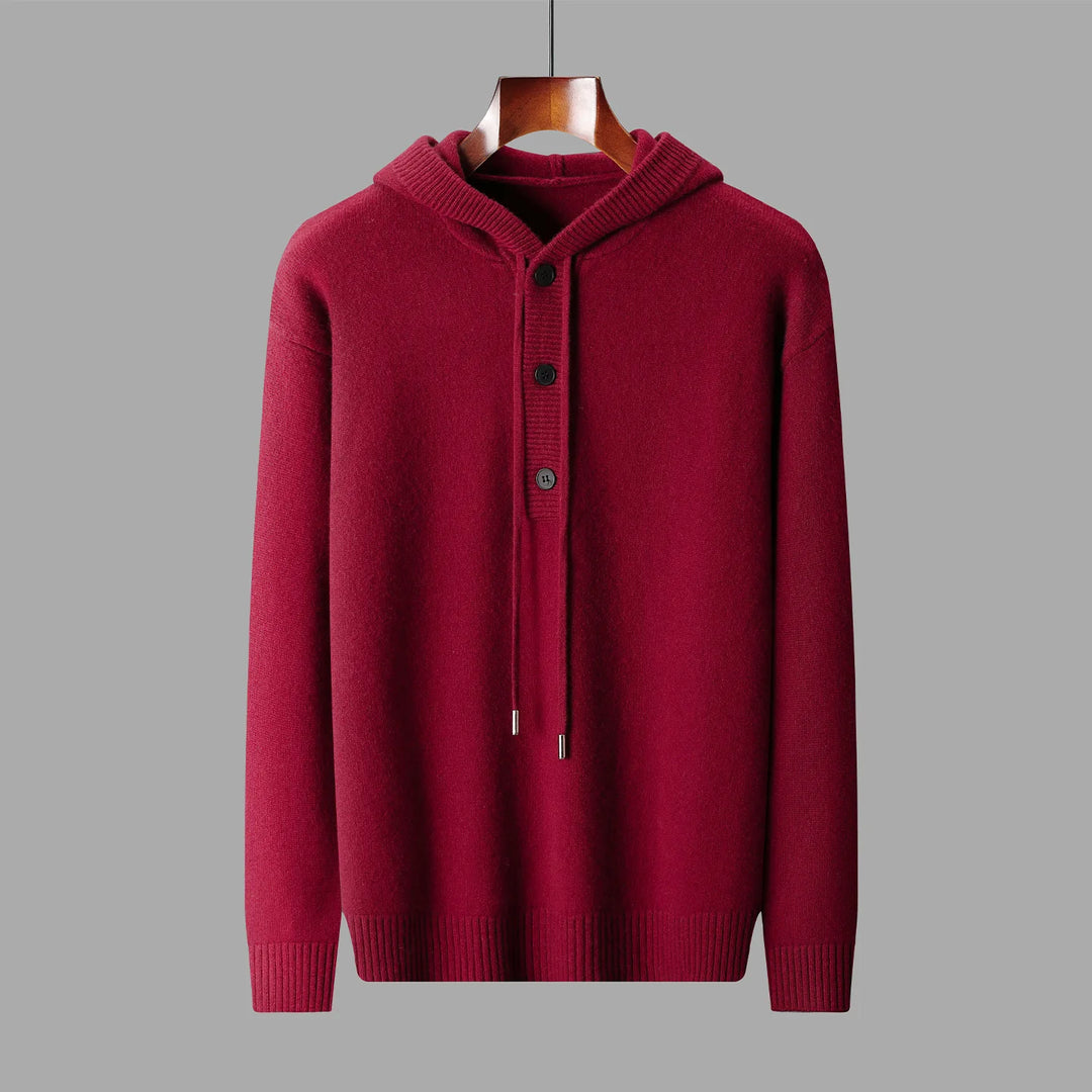Red hoodie on a hanger against a gray background