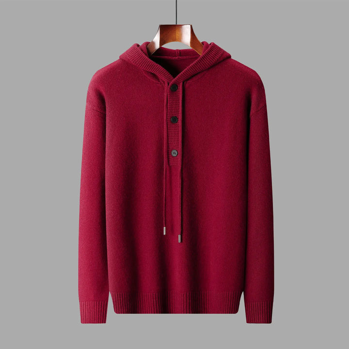 Red hoodie on a hanger against a gray background