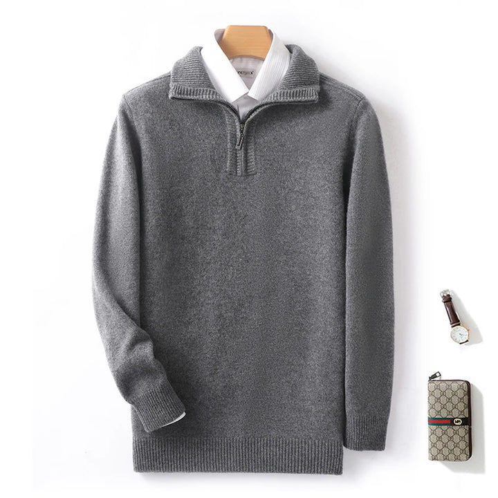 Gray sweater on a hanger with a Gucci wallet on a white background