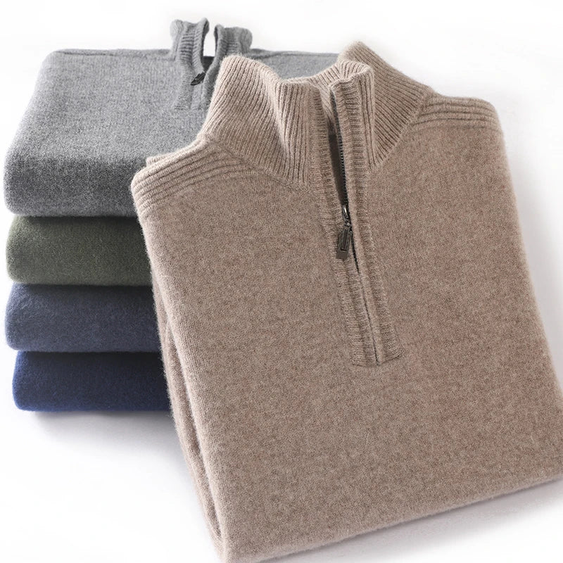 Folded quarter-zip sweaters in gray, green, and blue on a white background