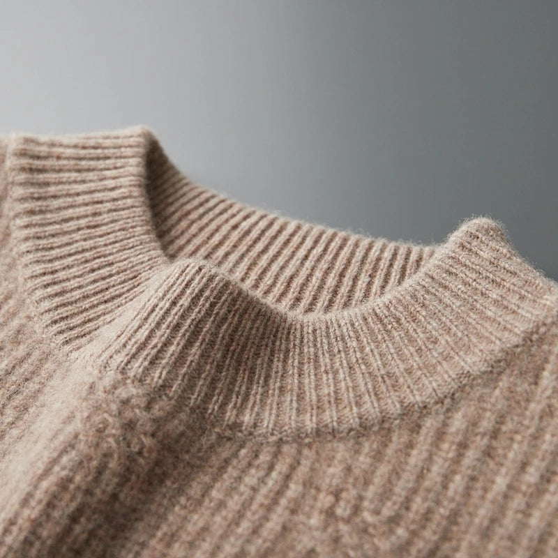 Close-up of a brown knitted sweater collar against a gray background