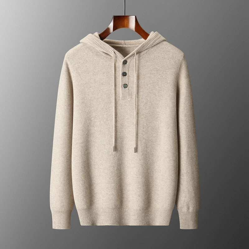 Beige hoodie on a wooden hanger against a gray background