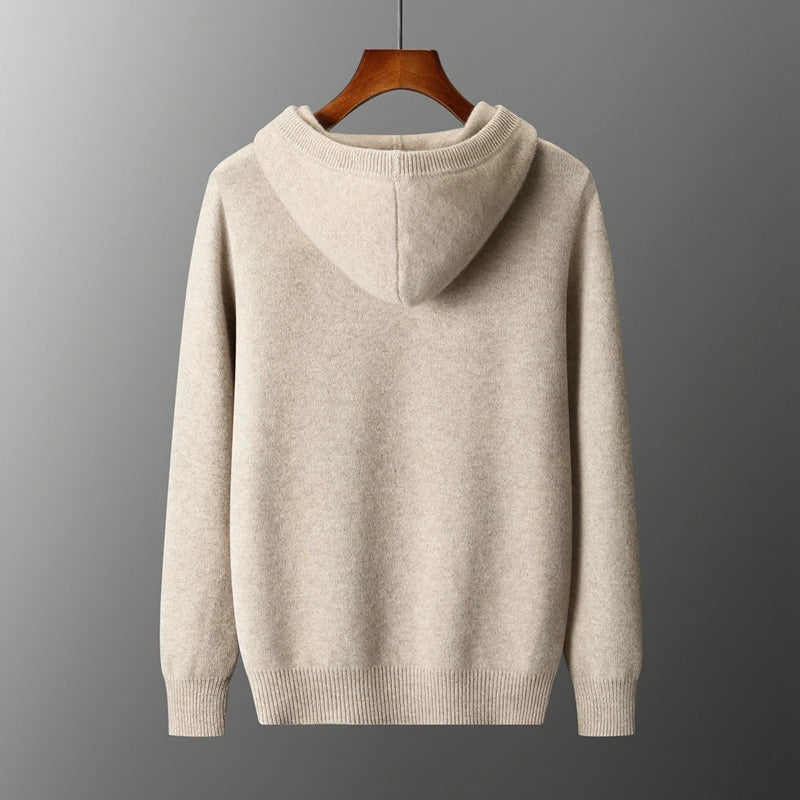 Beige hoodie on a wooden hanger against a gray background