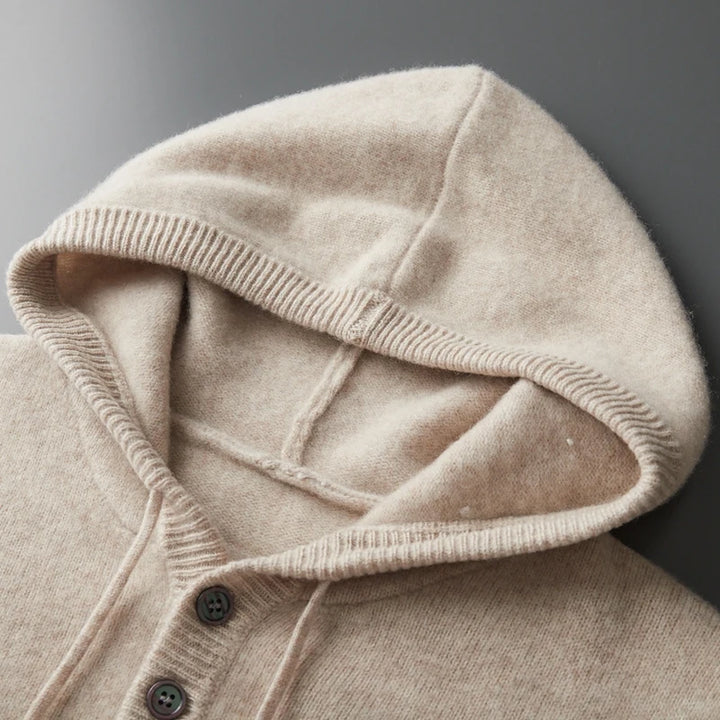 Close-up of a beige hooded garment with a dark background