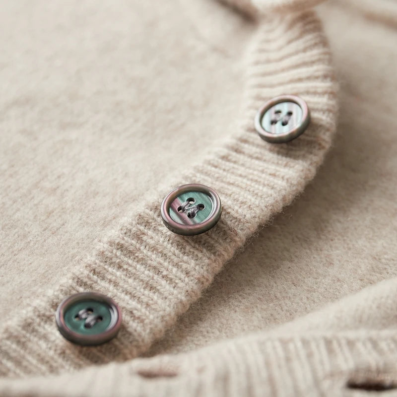 Close-up of a beige textured fabric with buttons on a light background