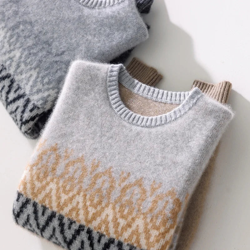 Two sweaters with a patterned design on a light background