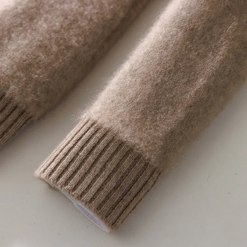 Close-up of a brown knitted sweater sleeve on a light background