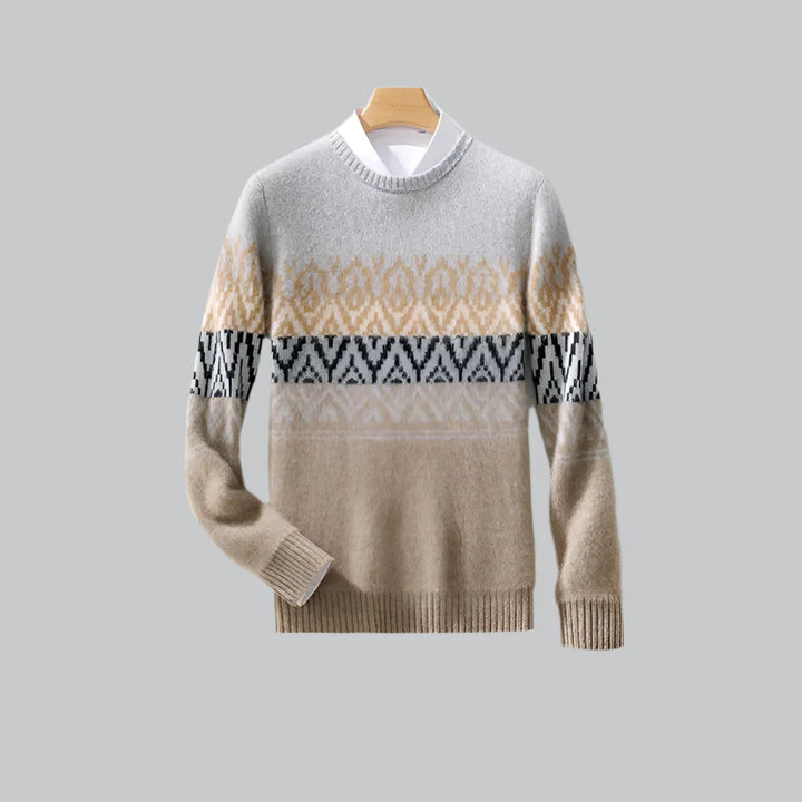 Beige and brown patterned sweater on a hanger against a gray background
