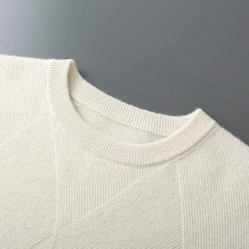 Close-up of a light gray sweater collar on a dark gray background