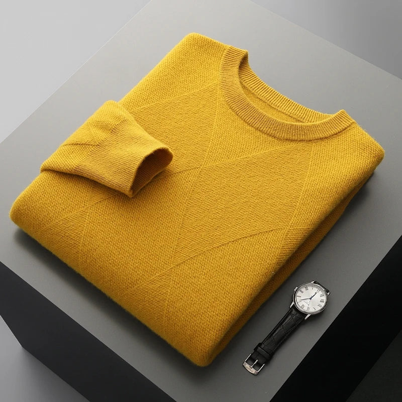 Yellow sweater and black watch on a gray surface