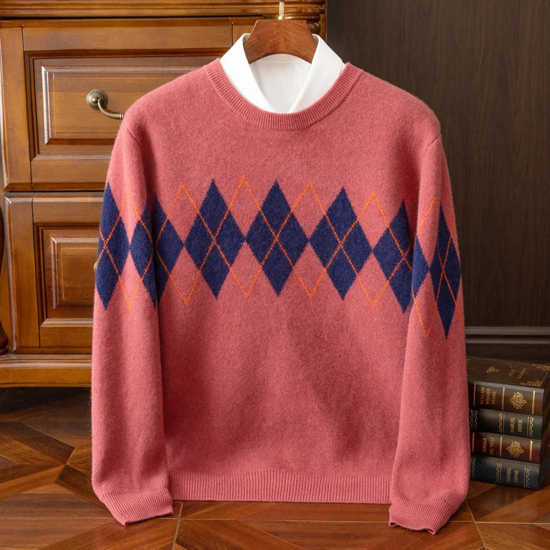 Pink sweater with blue diamond pattern on a wooden hanger against a wooden cabinet background