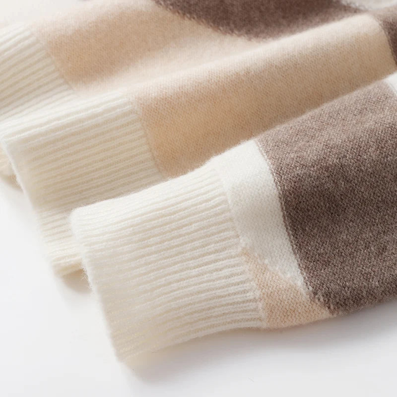 Close-up of a folded sweater with beige and brown stripes on a white background