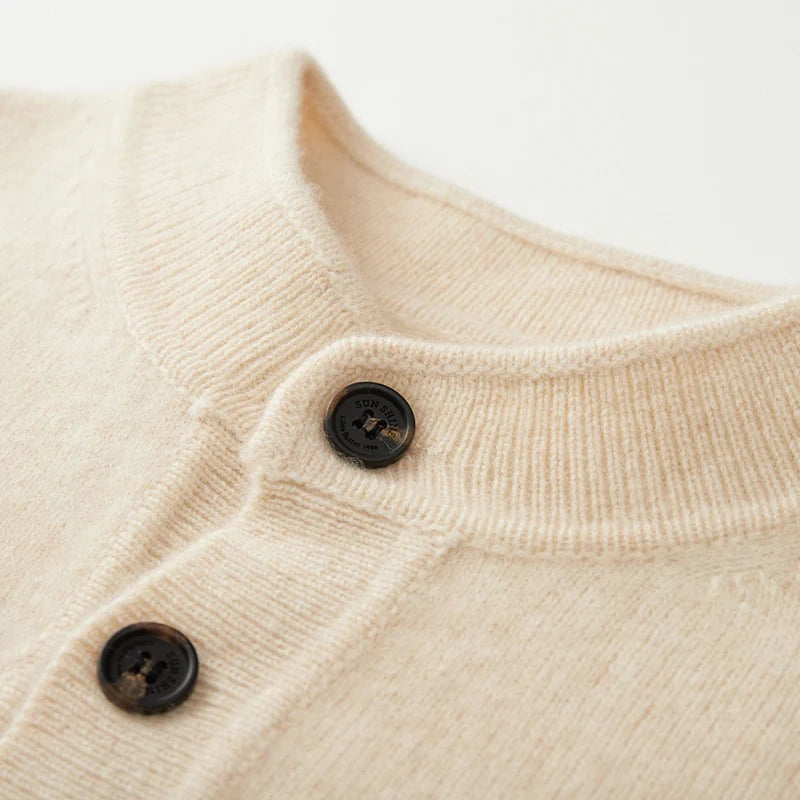 Close-up of a beige textured fabric with two dark buttons on a light background