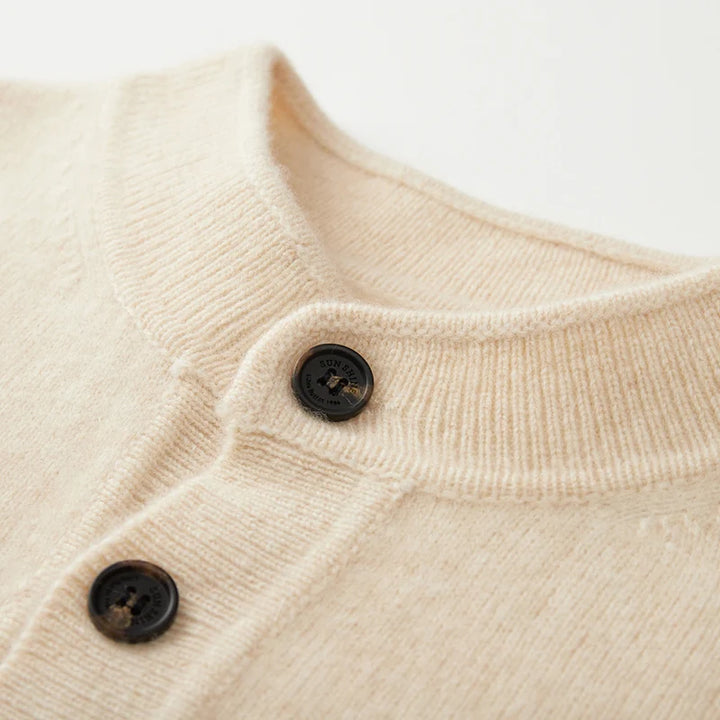Close-up of a beige textured fabric with two dark buttons on a light background