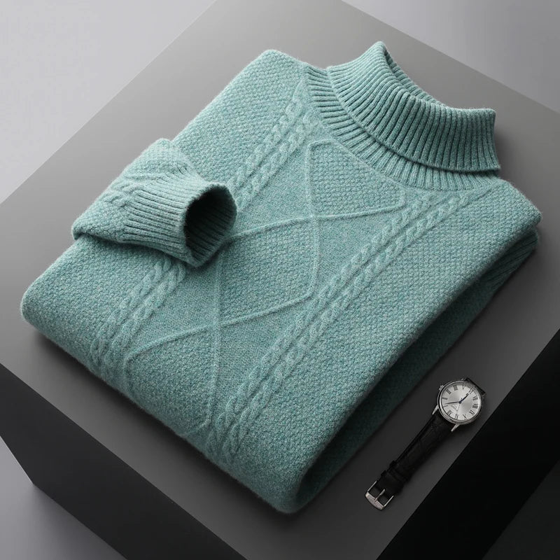 Folded teal sweater on a dark surface with a watch next to it