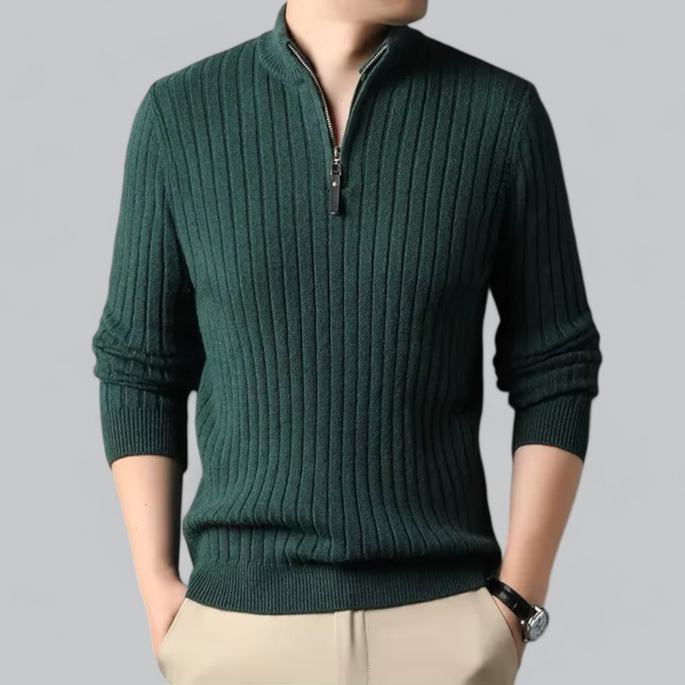 Green ribbed sweater with a zipper on a gray background