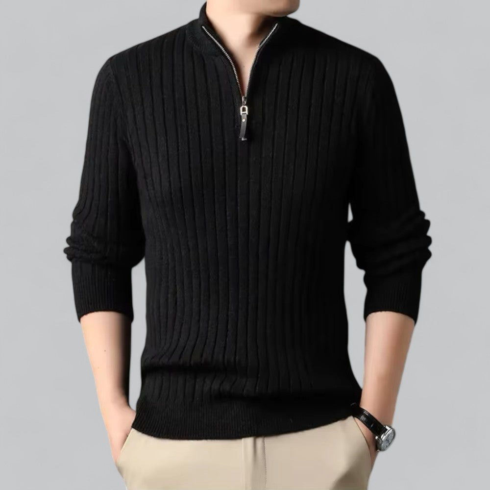 Black ribbed sweater with a zipper on a gray background