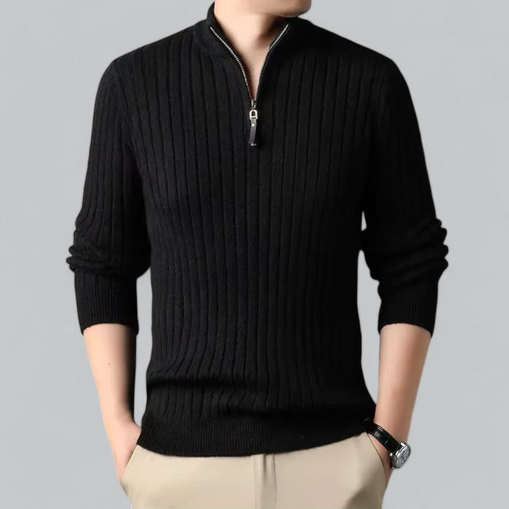Black ribbed sweater with a zipper on a gray background