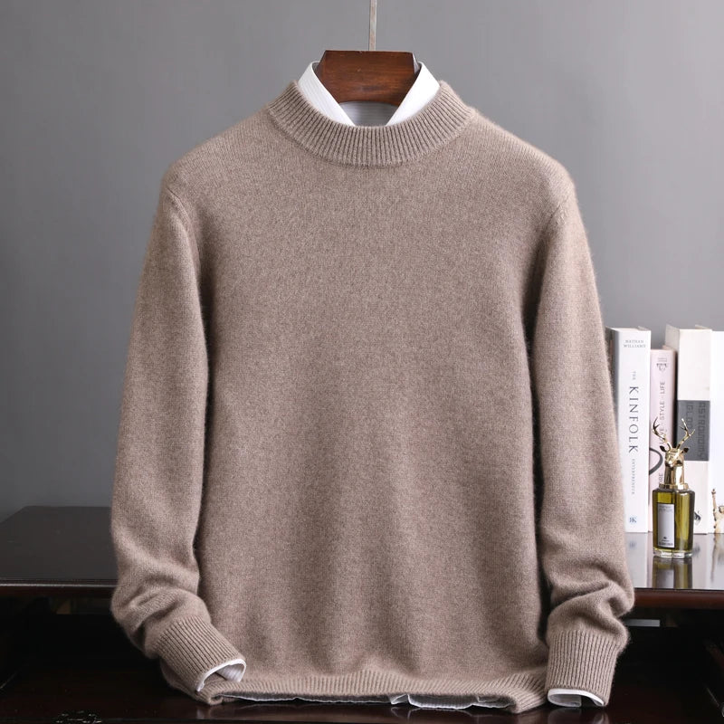 Beige sweater on a hanger against a gray background
