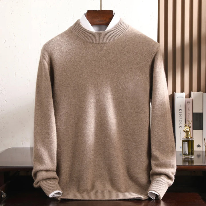 Beige sweater on a hanger against a neutral background