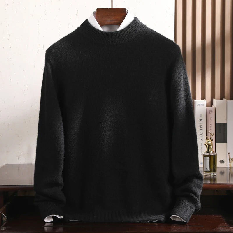 Black sweater on a wooden hanger against a neutral background