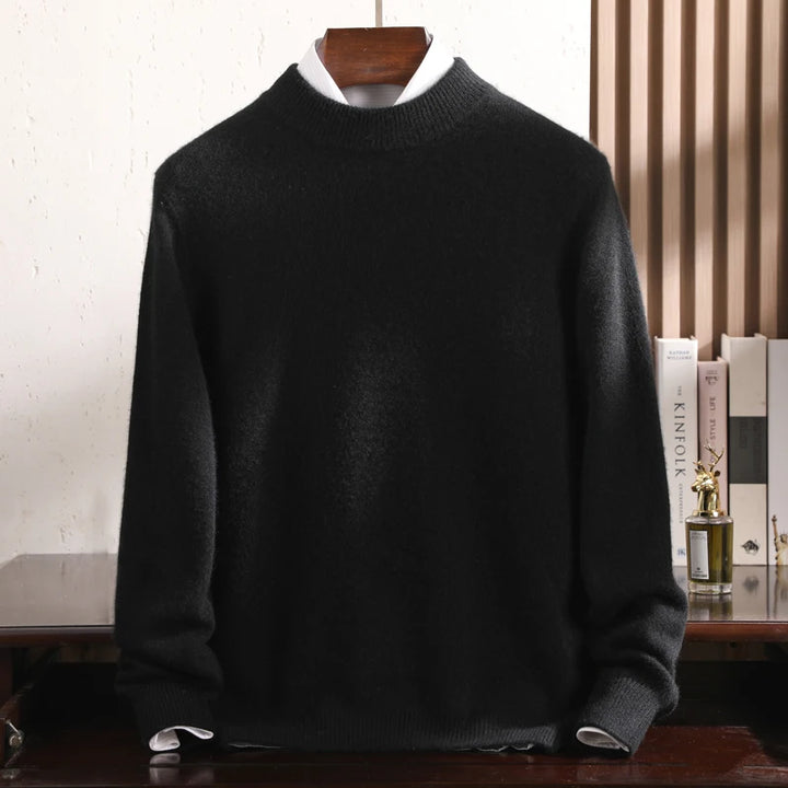 Black sweater on a wooden hanger against a neutral background