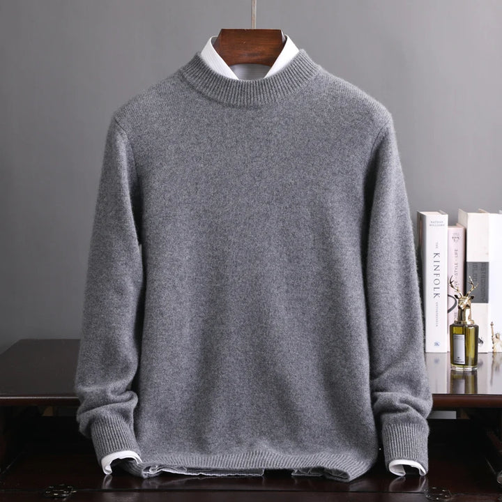 Gray sweater on a hanger against a gray background
