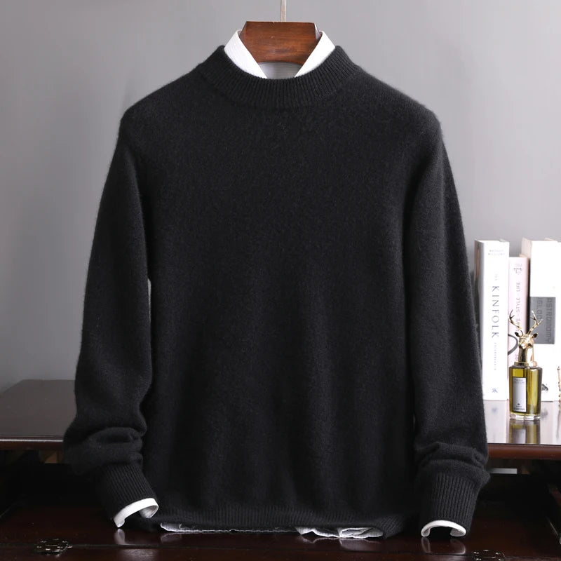 Black sweater on a wooden hanger against a gray background