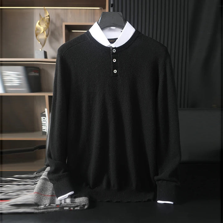 Black sweater with white collar on a hanger against a dark background