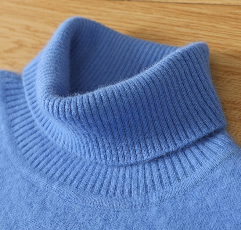 Close-up of a blue knitted sweater collar on a wooden surface
