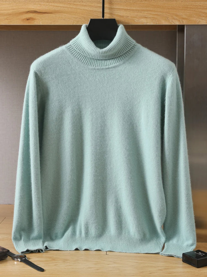 Light green sweater on a hanger against a neutral background