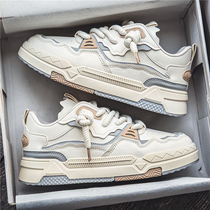 Pair of beige and brown sneakers in a box