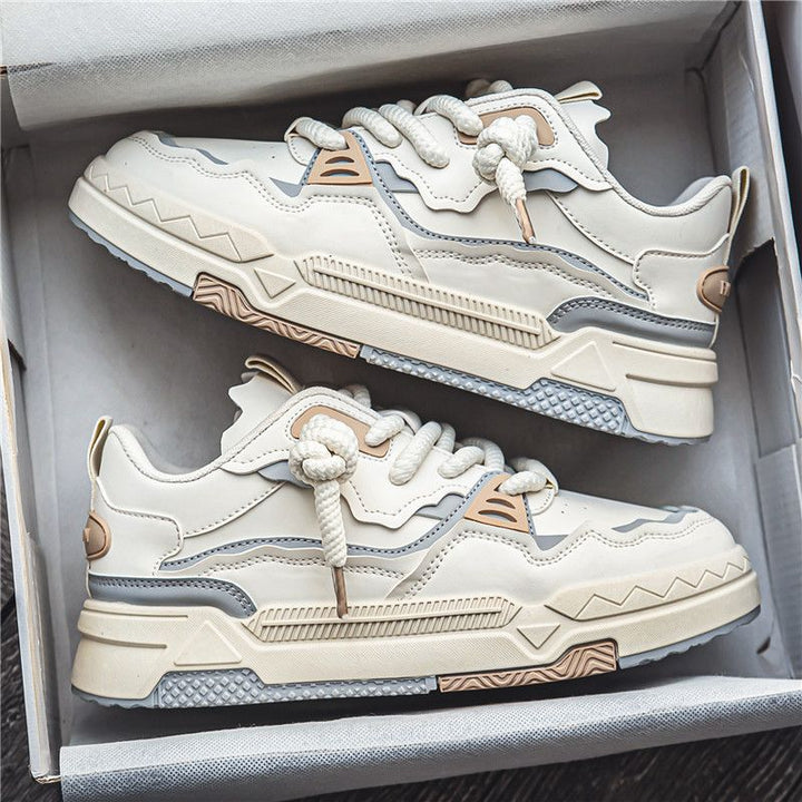Pair of beige and brown sneakers in a box