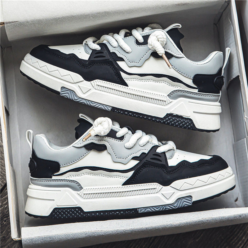 Pair of black and white sneakers in an open box